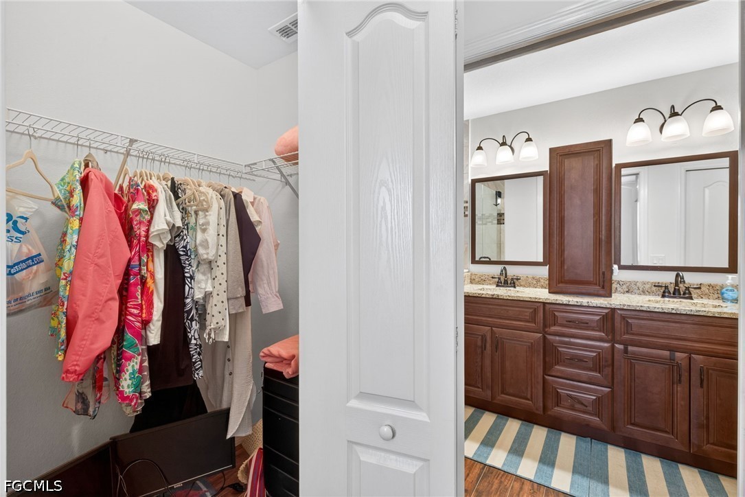 8251 Pathfinder Loop, Unit 621 Fort Myers, FL 33919 - Photo 24 of 30 a view of walk in closet with clothes