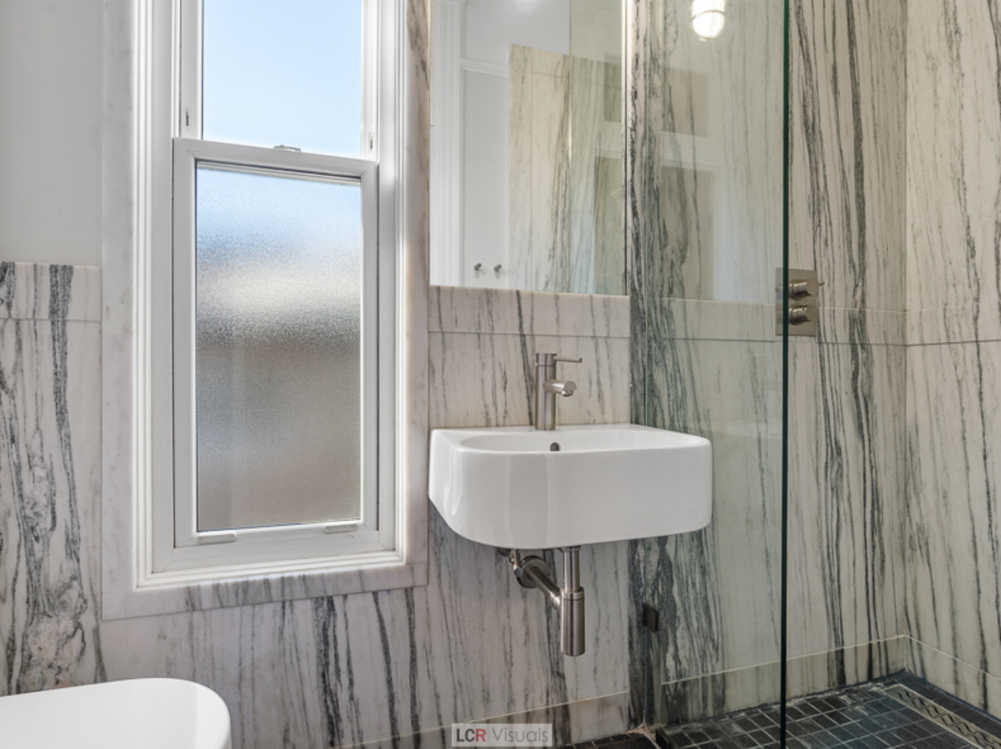 1012 Chicago Avenue Oak Park, IL 60302 - Photo 18 of 27 a bathroom with a sink a mirror and a toilet