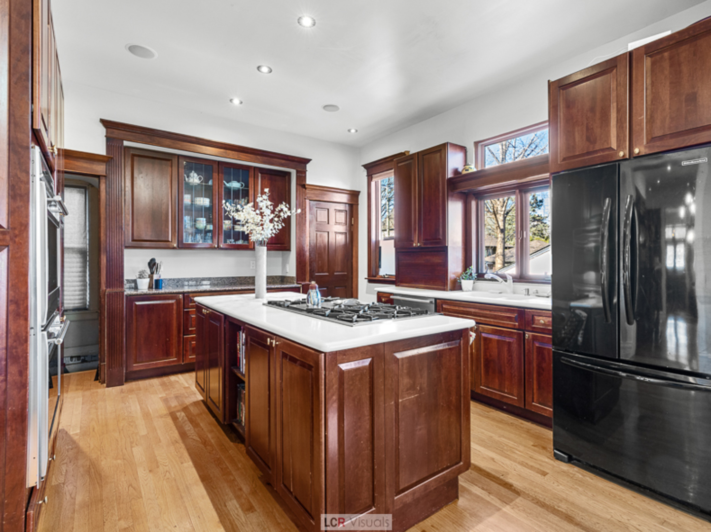1012 Chicago Avenue Oak Park, IL 60302 - Photo 8 of 27 a kitchen with stainless steel appliances granite countertop a stove top oven a refrigerator a sink and dishwasher with wooden floor