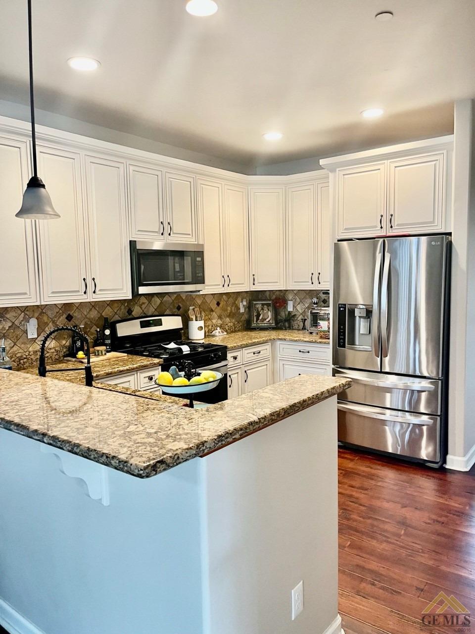 Undisclosed Address San Miguel, CA 93451 - Photo 6 of 12 a kitchen with a refrigerator a microwave a sink and a stove