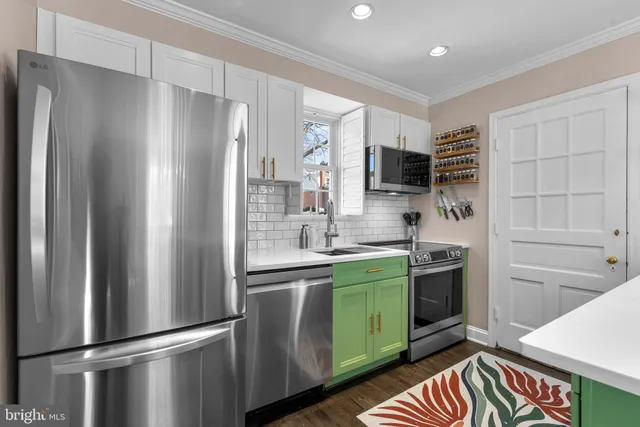 a kitchen with stainless steel appliances granite countertop a refrigerator and a stove top oven