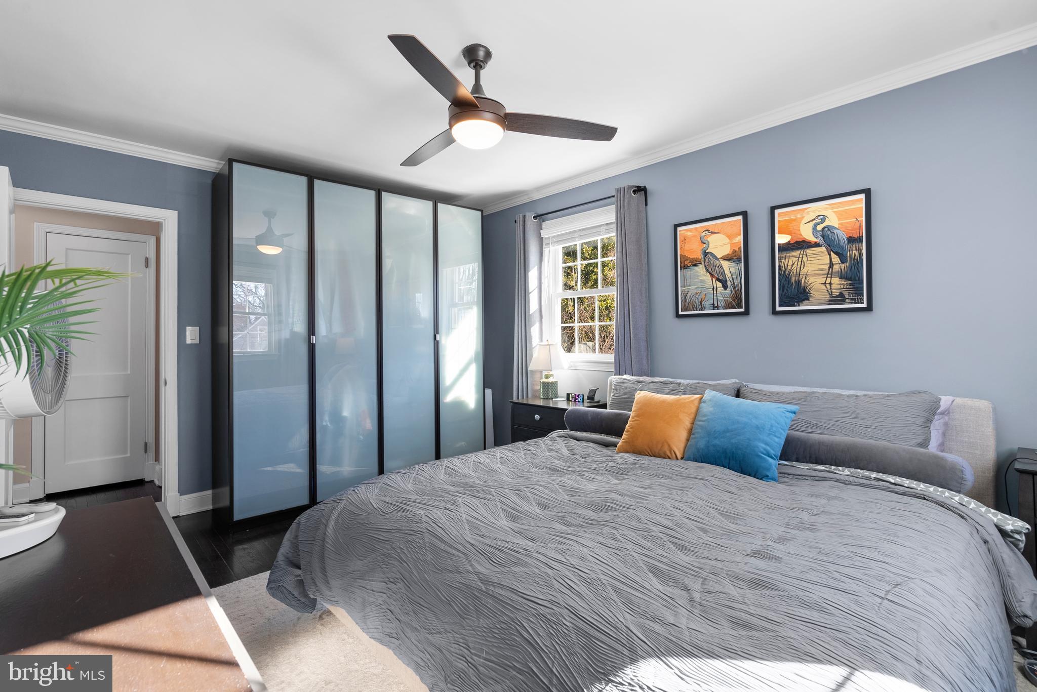 707 Forest Glen Road Silver Spring, MD 20901 - Photo 22 of 48 a bedroom with a large bed and a chandelier