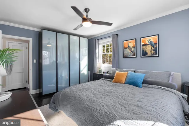 a bedroom with a large bed and a chandelier