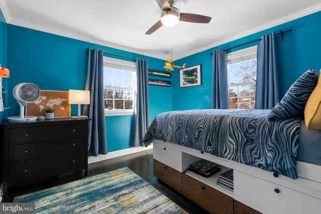 a living room with a bed and a window