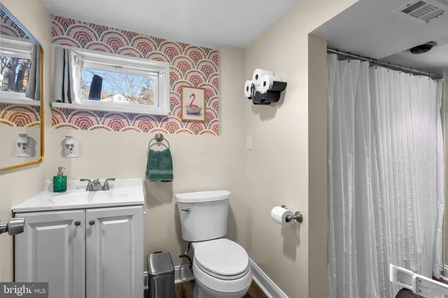 a white toilet sitting next to a bathroom sink