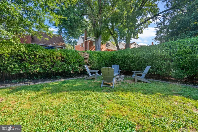 a view of a chair and table in the garden