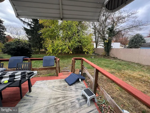 a view of a deck with wooden floor and outdoor seating