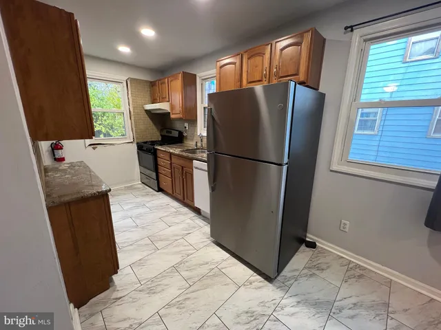 a kitchen with stainless steel appliances a refrigerator sink and microwave