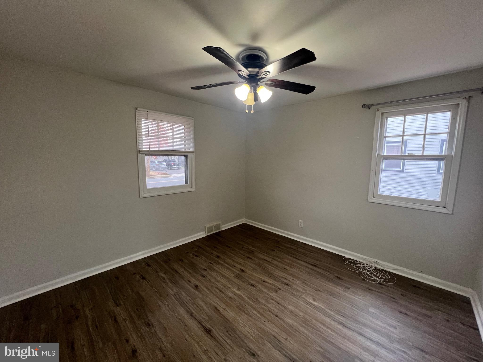 213 Nicholson Road West Collingswood Heights, NJ 08059 - Photo 9 of 18 a view of an empty room with wooden floor and a window