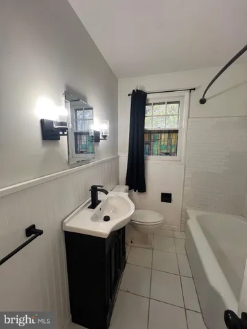 a bathroom with a sink a toilet and bathtub