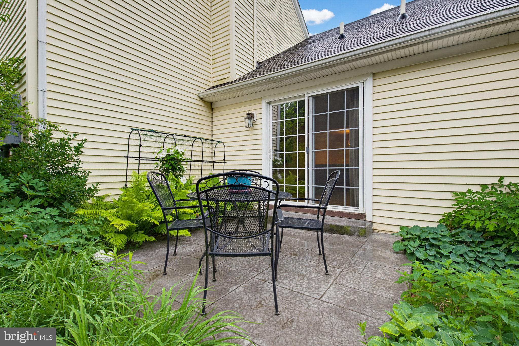 1037 Kent Garden Lititz, PA 17543 - Photo 8 of 31 a view of backyard with a table and chairs and potted plants