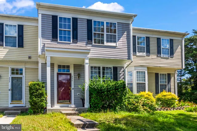 front view of a brick house with a yard