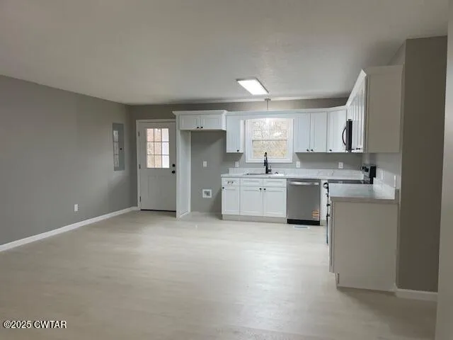 a kitchen with a sink stove and cabinets