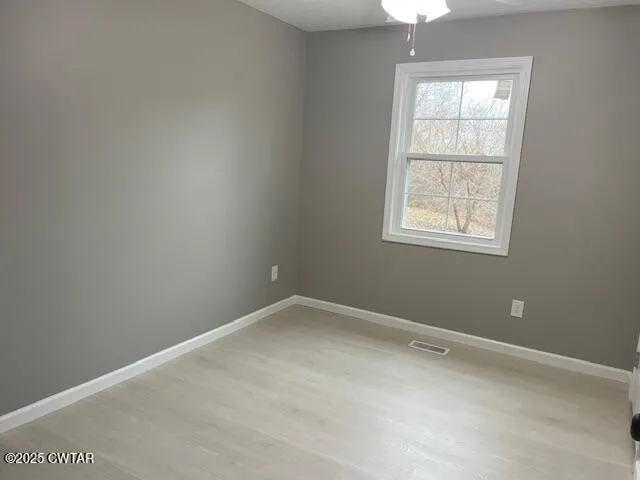 an empty room with windows and closet
