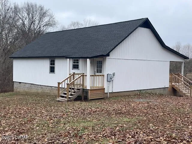 a backyard of a house with table and chairs