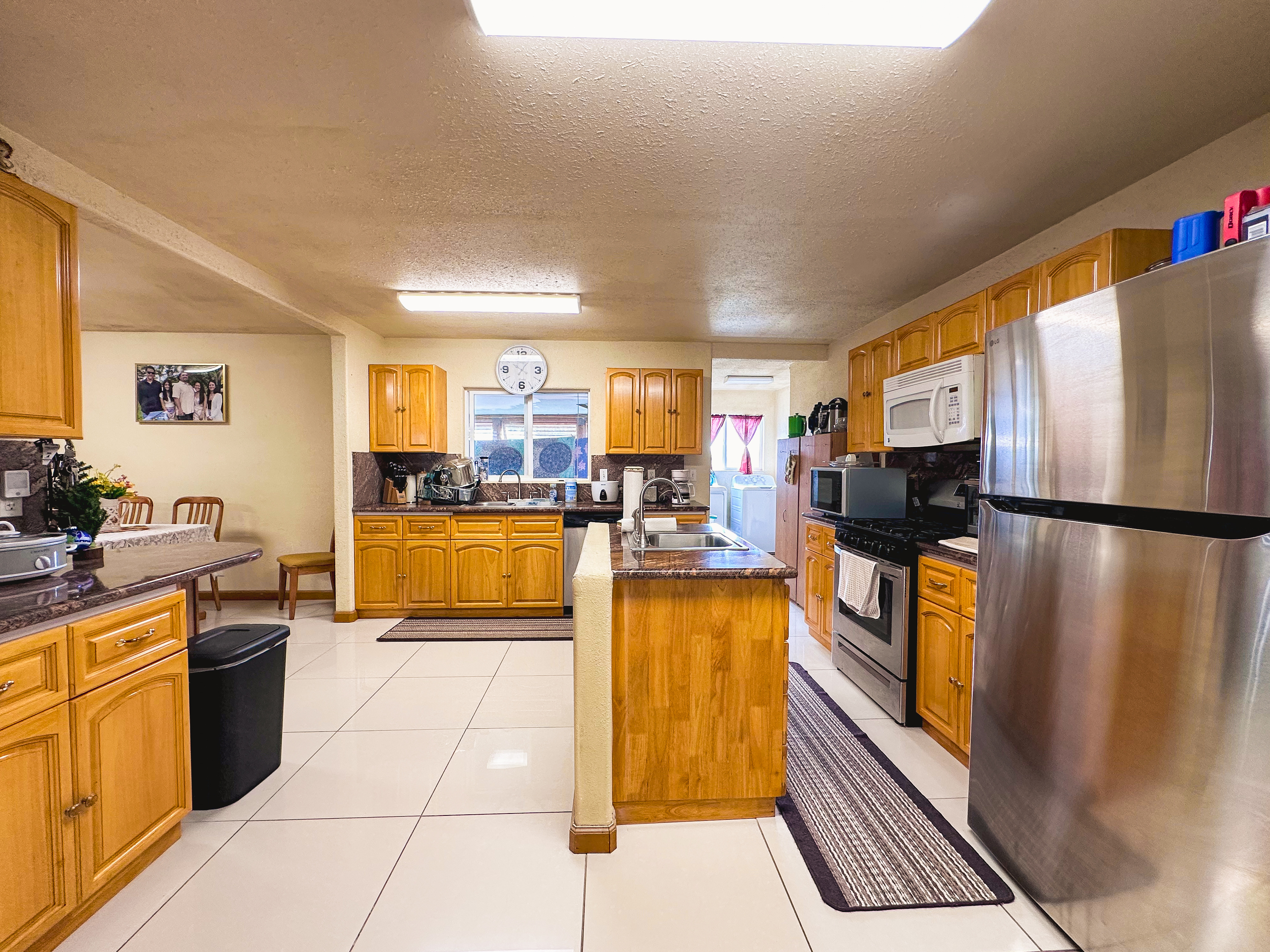 18-7747 North Kulani Road Mountain View, HI 96771 - Photo 20 of 28 a kitchen with stainless steel appliances granite countertop a refrigerator and a stove top oven