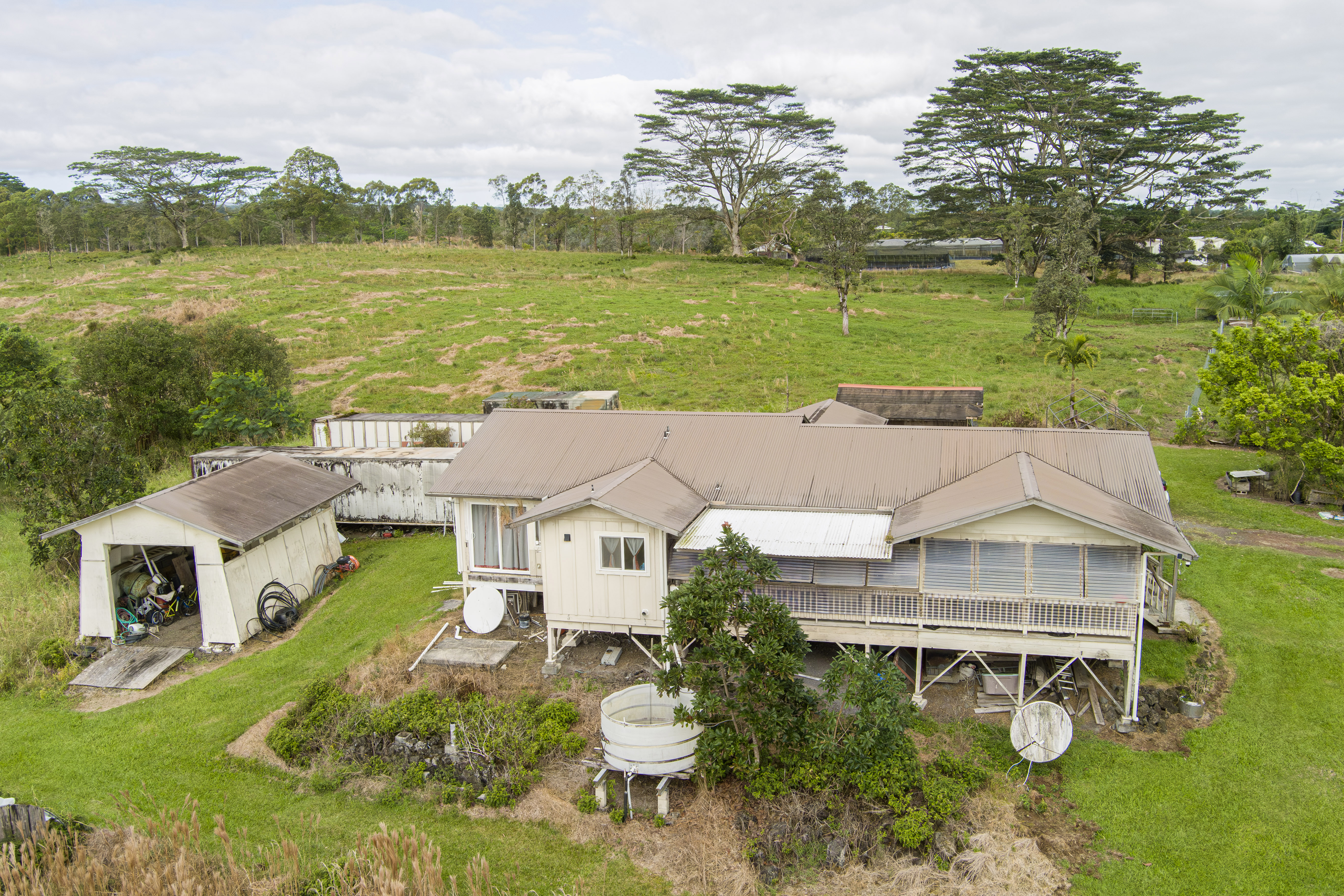 18-7747 North Kulani Road Mountain View, HI 96771 - Photo 2 of 28 an aerial view of a house with a garden and lake view