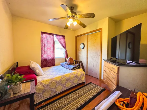 a bedroom with a bed and a chandelier