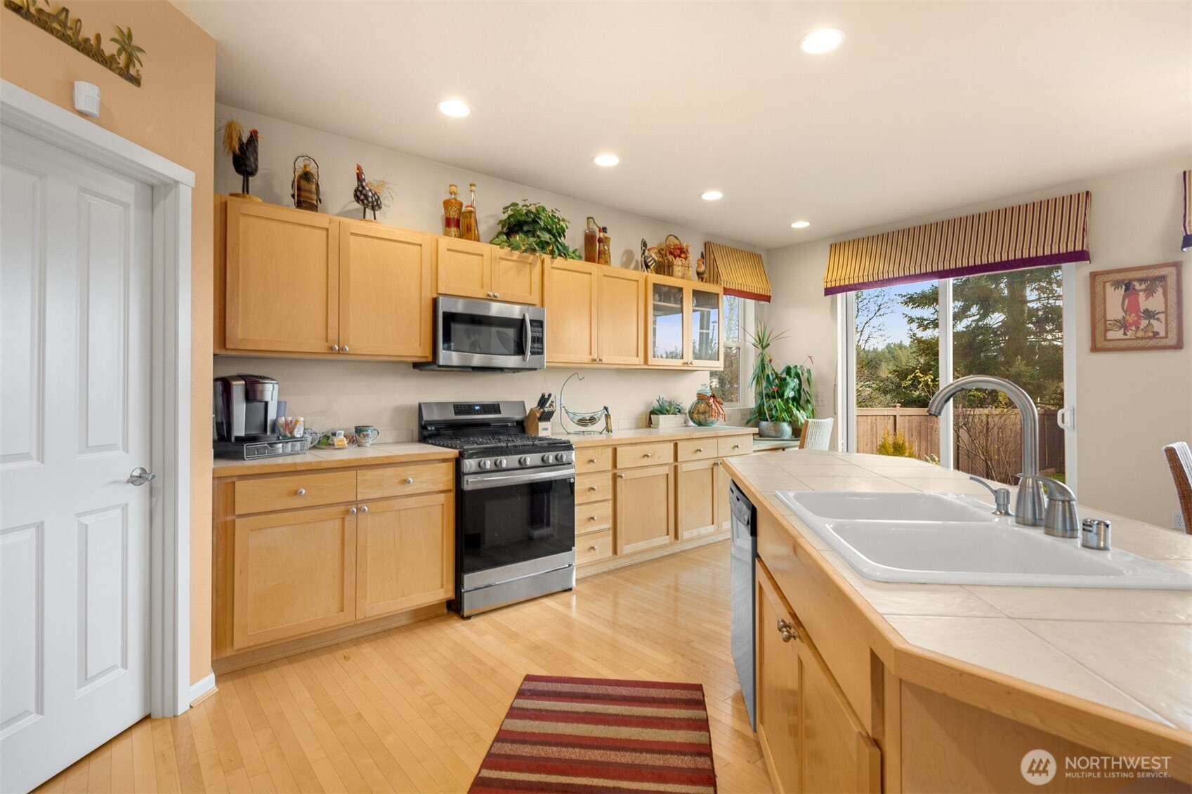 1306 68th Street Southeast Auburn, WA 98092 - Photo 27 of 39 a kitchen with stainless steel appliances granite countertop a sink and cabinets