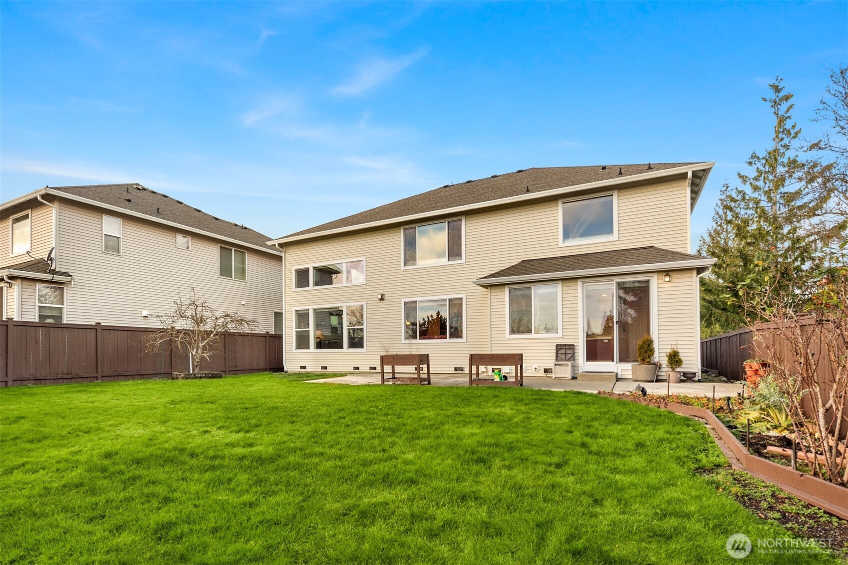 1306 68th Street Southeast Auburn, WA 98092 - Photo 29 of 39 a front view of house with a garden and patio