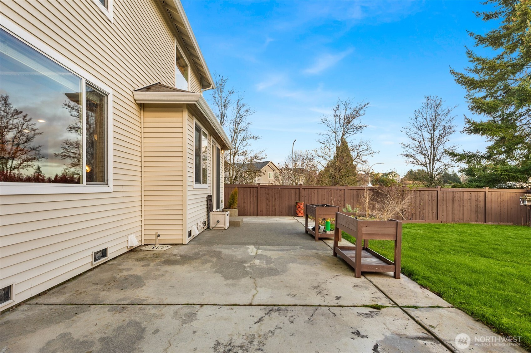 1306 68th Street Southeast Auburn, WA 98092 - Photo 33 of 39 a view of backyard with seating space and wooden fence