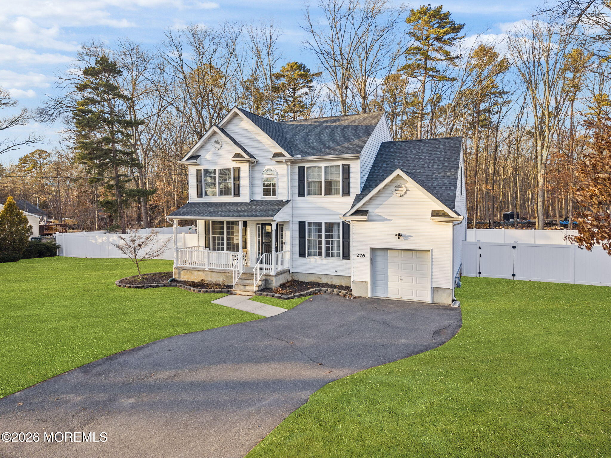 a view of a house with a yard and sitting area