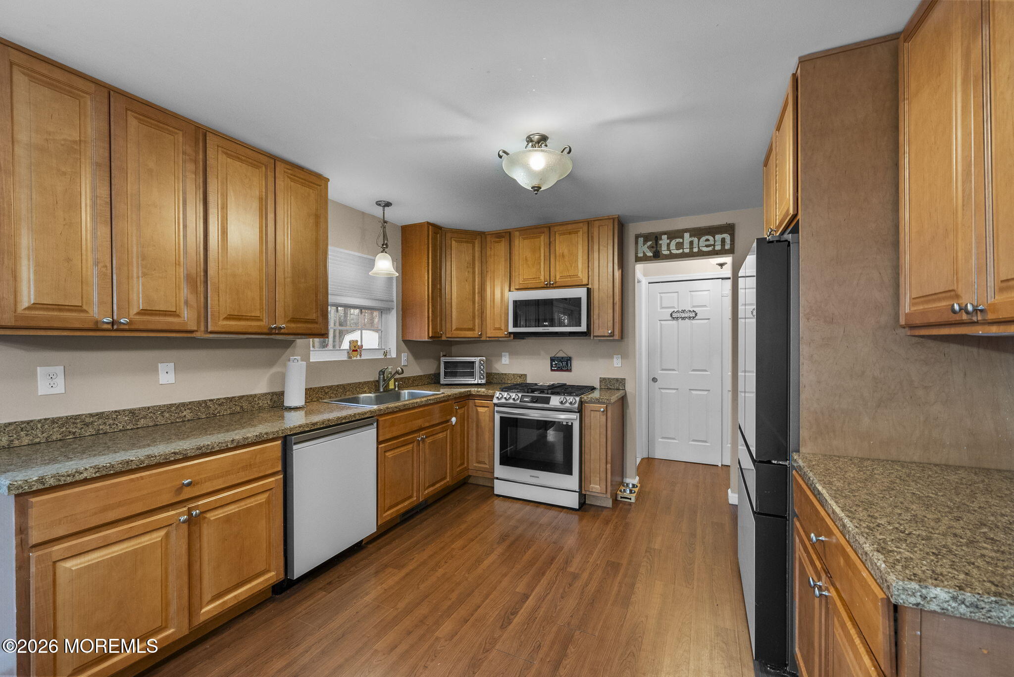 276 Andrews Road Jackson, NJ 08527 - Photo 14 of 46 a kitchen with stainless steel appliances granite countertop a refrigerator a stove top oven and sink with wooden floor