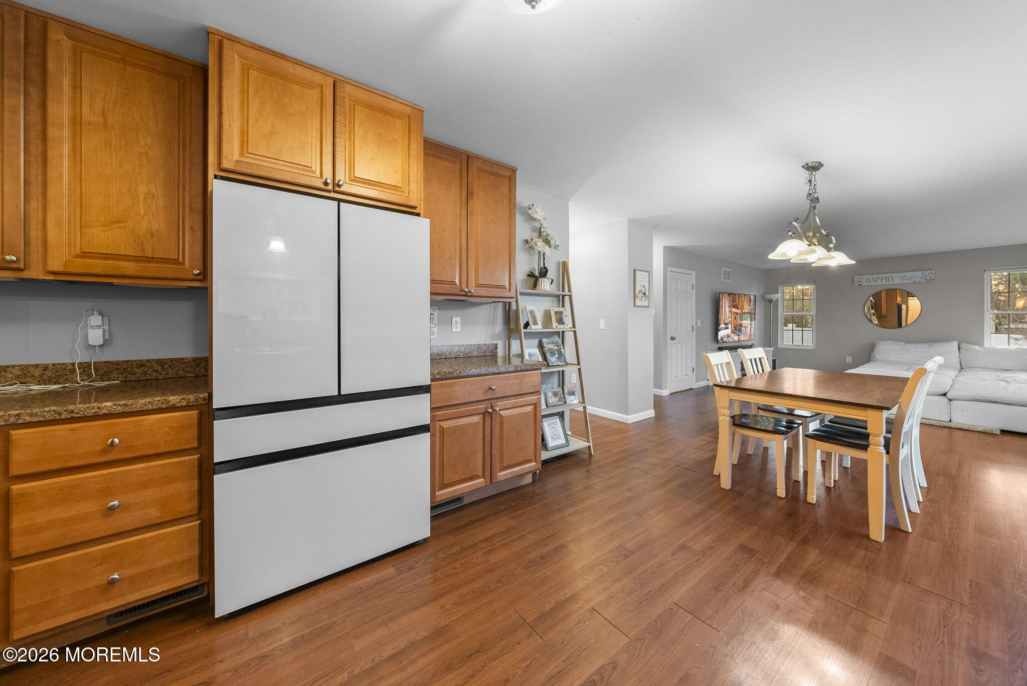 276 Andrews Road Jackson, NJ 08527 - Photo 15 of 46 a kitchen with stainless steel appliances granite countertop a refrigerator a stove a dining table and chairs with wooden floor
