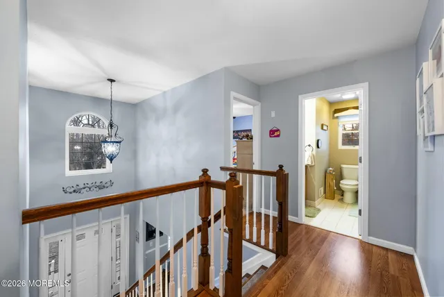 a view of an entryway with wooden floor and windows