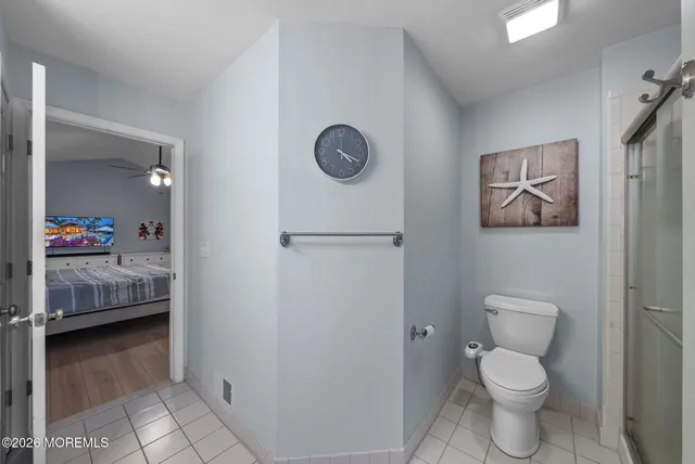 a bathroom with a toilet and a shower