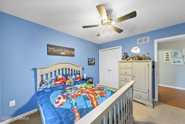 a bedroom with furniture a baby crib and a dresser