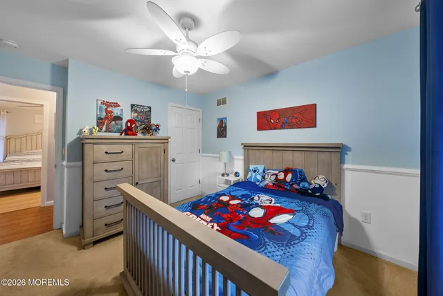 a bedroom with furniture and a baby crib