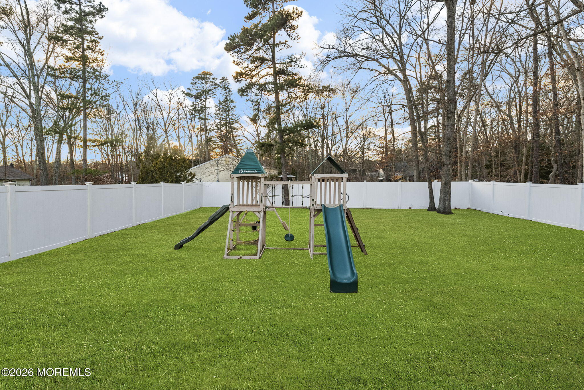 276 Andrews Road Jackson, NJ 08527 - Photo 43 of 46 a view of a backyard with a slide and a tree