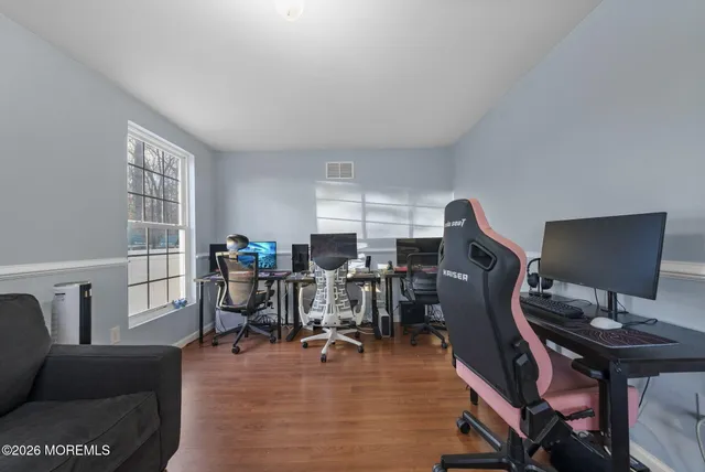 a dining room with furniture and wooden floor