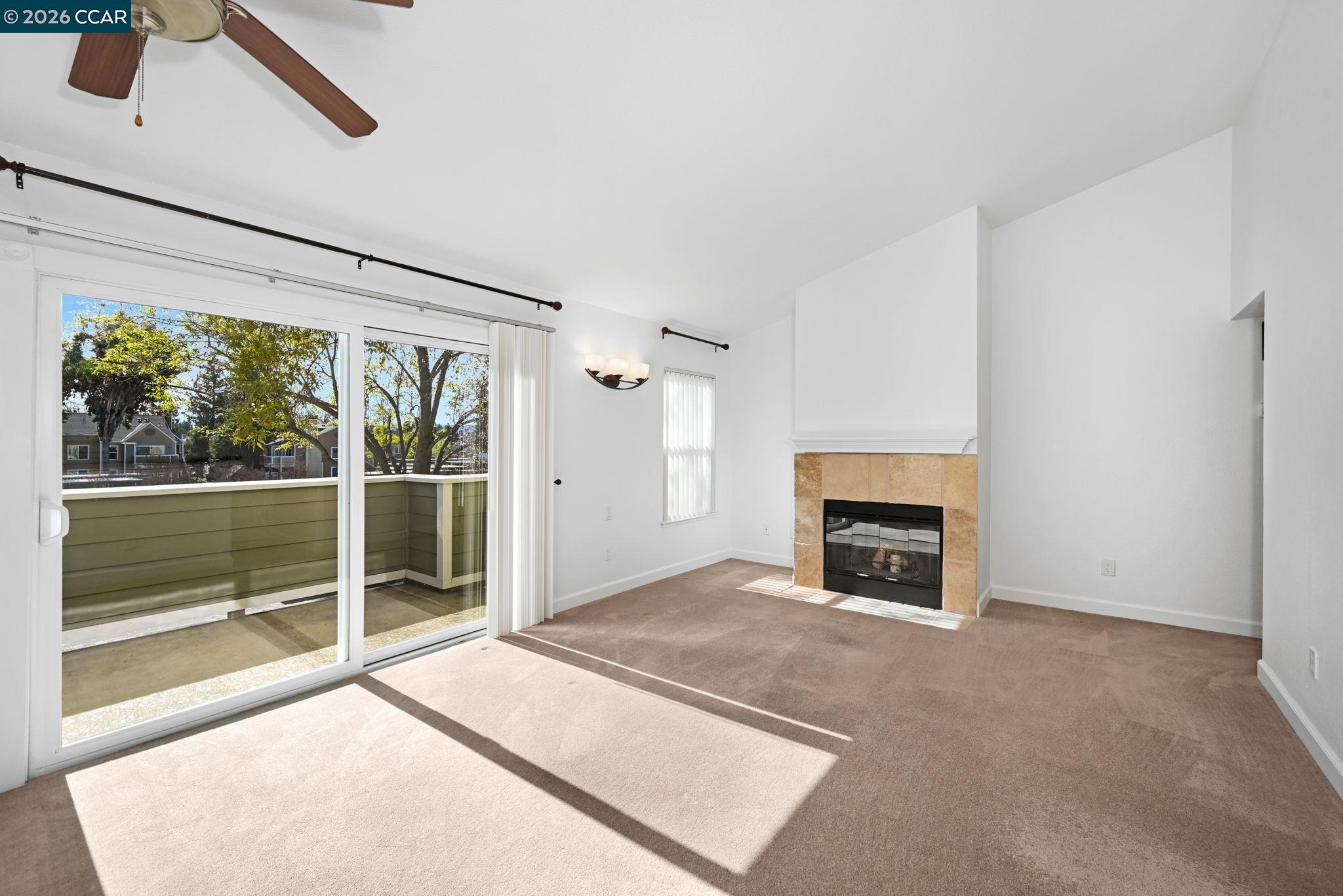 140 Reflections Drive, Unit 21 San Ramon, CA 94583 - Photo 6 of 34 a view of empty room with floor to ceiling window and fireplace