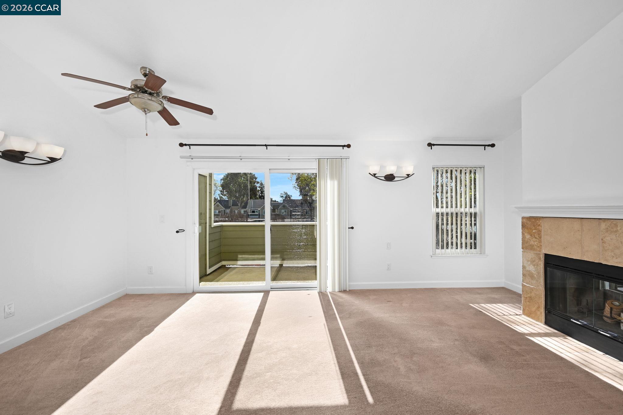 140 Reflections Drive, Unit 21 San Ramon, CA 94583 - Photo 7 of 34 a view of a room with wooden floor a ceiling fan and window