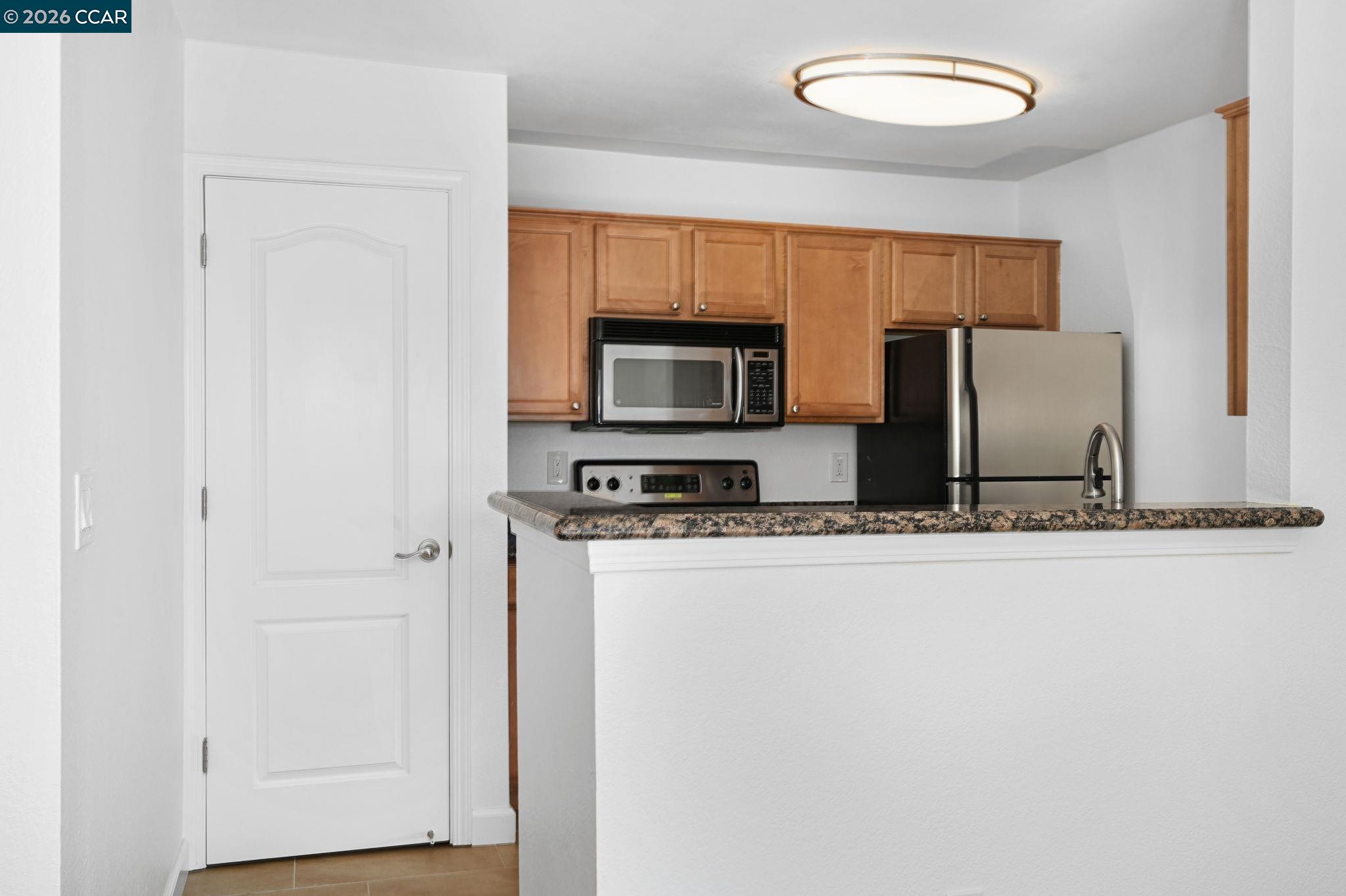 140 Reflections Drive, Unit 21 San Ramon, CA 94583 - Photo 8 of 34 a view of kitchen with stainless steel appliances wooden floor and window