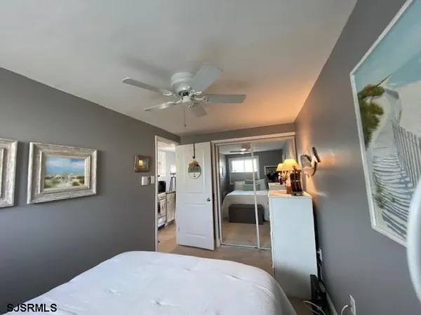 a bedroom with a bed and ceiling fan
