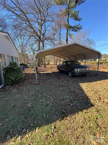 a view of a yard with a car parked in it