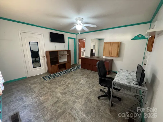 a view of a livingroom with furniture and a flat screen tv