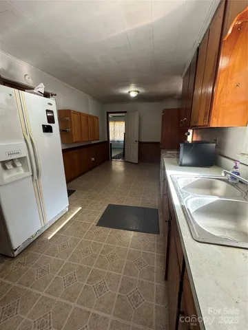 a kitchen with a sink a stove and a refrigerator