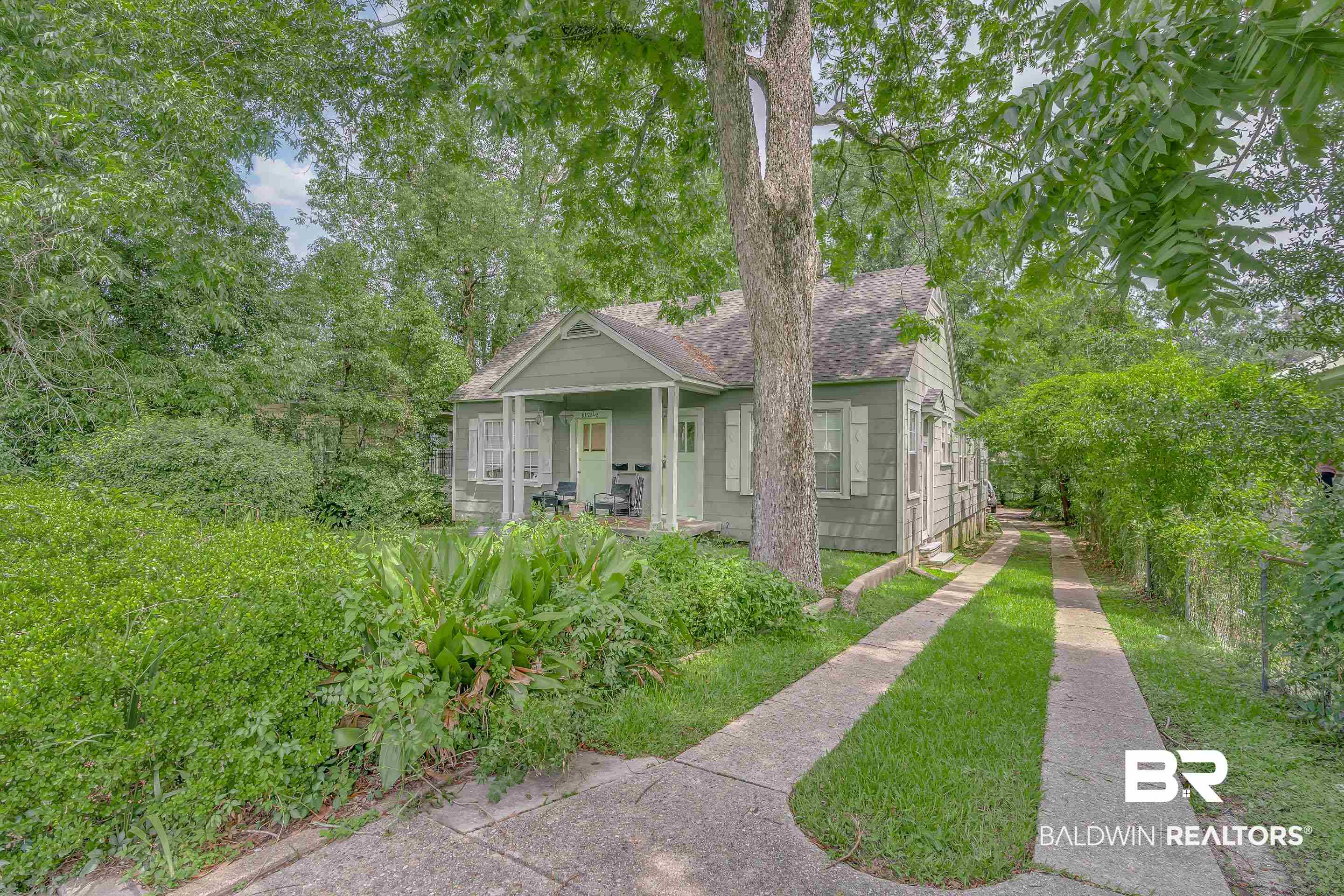 1852 Old Shell Road Mobile, AL 36607 - Photo 2 of 26 View of front of property featuring a shingled roof