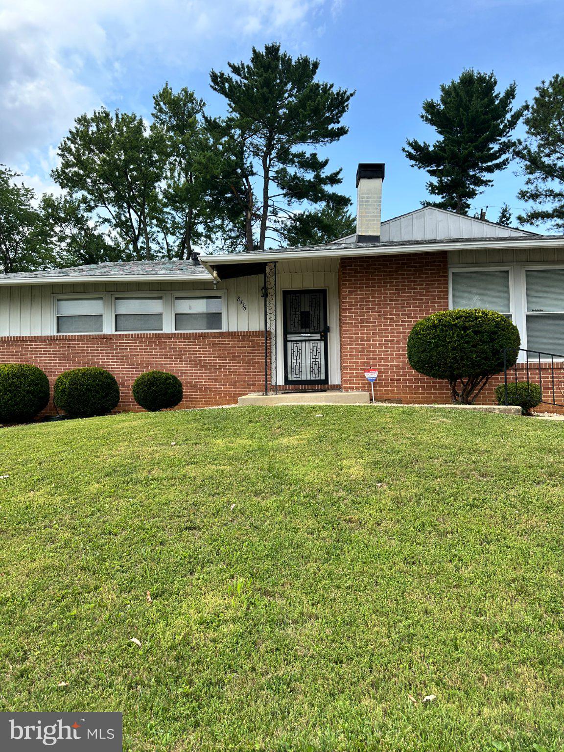 8336 Scotts Level Road Baltimore, MD 21208 - Photo 2 of 55 Charming brick home with lush greenery.