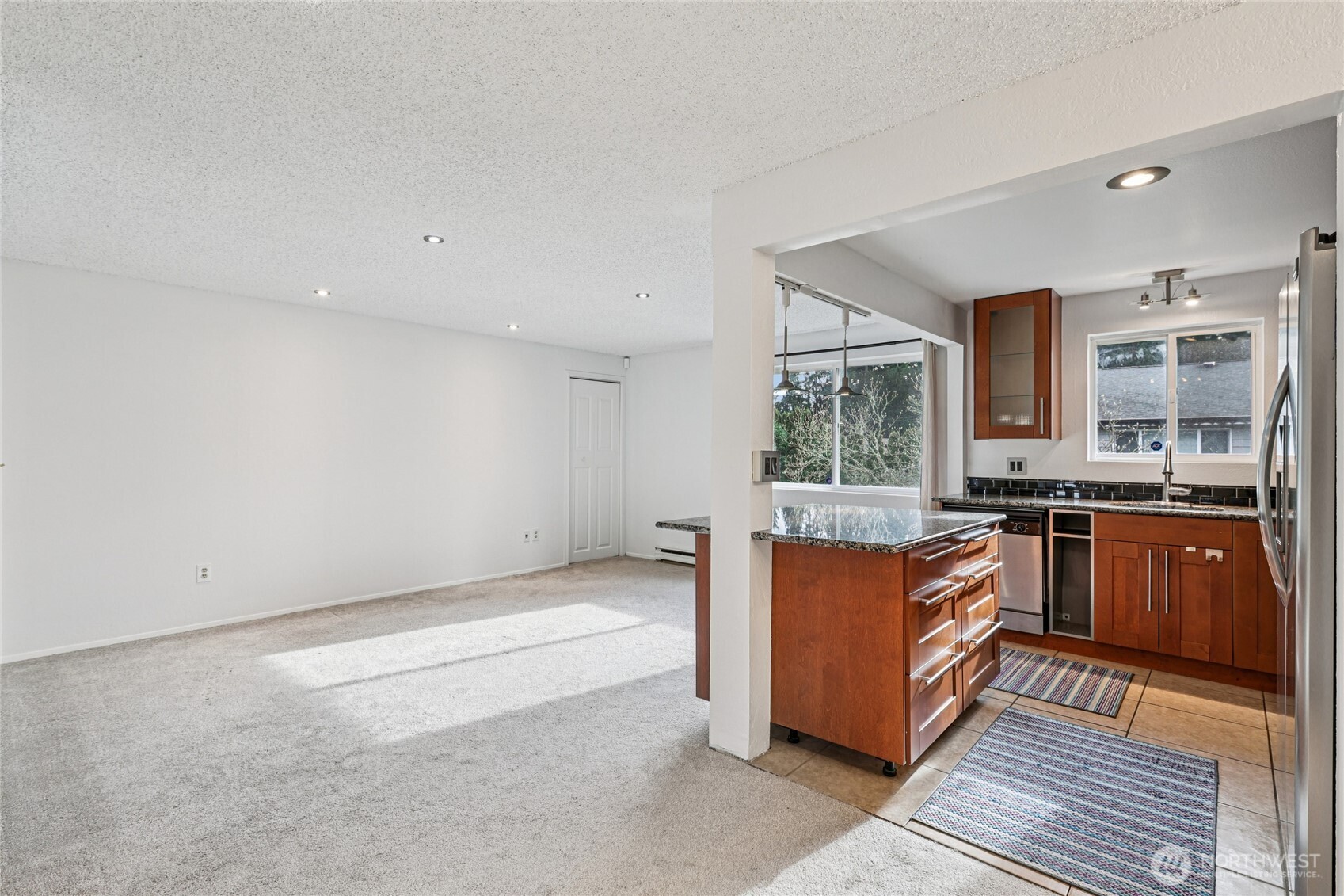 7909 218th Street Southwest, Unit 4 Edmonds, WA 98026 - Photo 6 of 29 a kitchen with stainless steel appliances granite countertop a stove and a sink