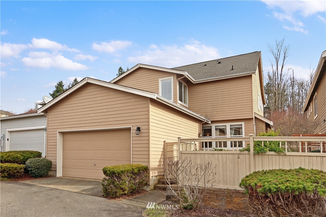 17013 Parkside Way Southeast Renton, WA 98058 - Photo 2 of 26 a front view of a house with a garage
