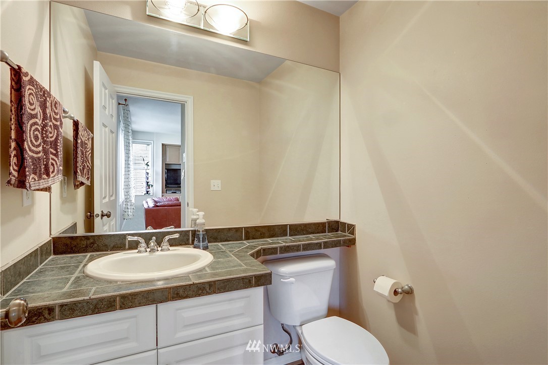 17013 Parkside Way Southeast Renton, WA 98058 - Photo 13 of 26 a bathroom with a granite countertop toilet sink and mirror