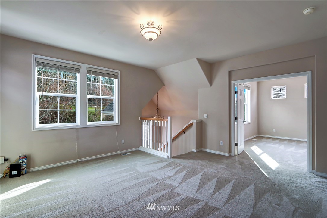 17013 Parkside Way Southeast Renton, WA 98058 - Photo 15 of 26 an empty room with a fireplace and windows