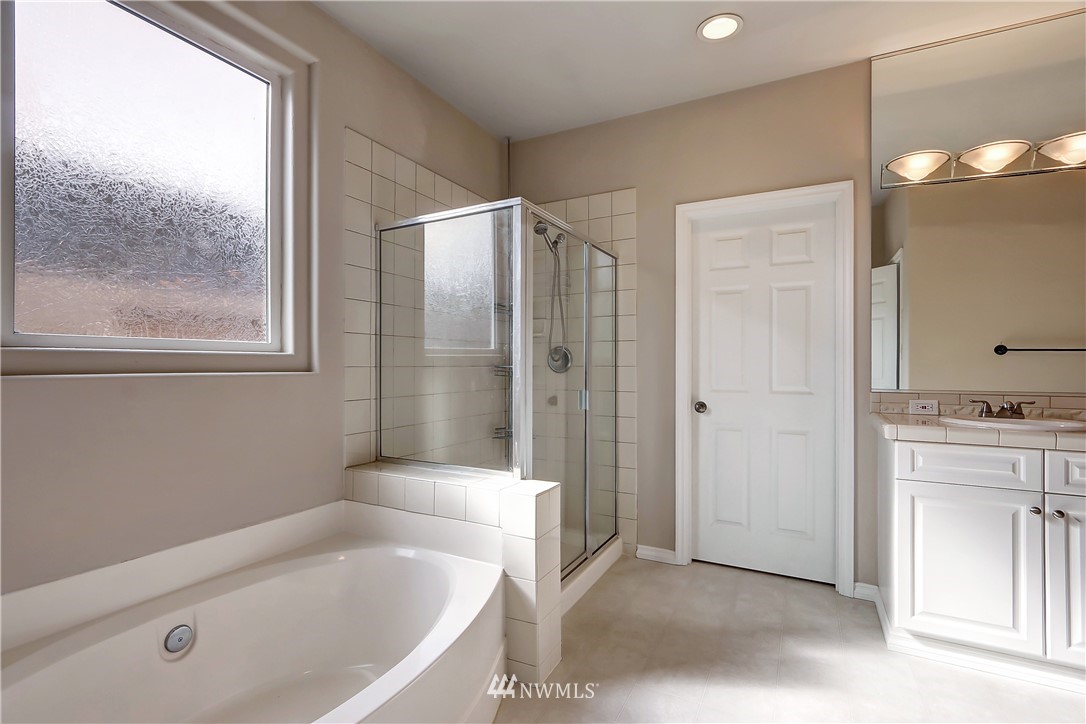 17013 Parkside Way Southeast Renton, WA 98058 - Photo 18 of 26 a bathroom with a tub sink and mirror