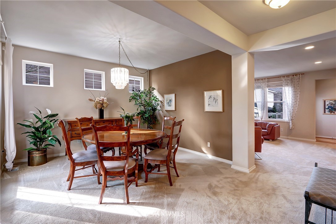 17013 Parkside Way Southeast Renton, WA 98058 - Photo 3 of 26 a view of a dining room with furniture and chandelier