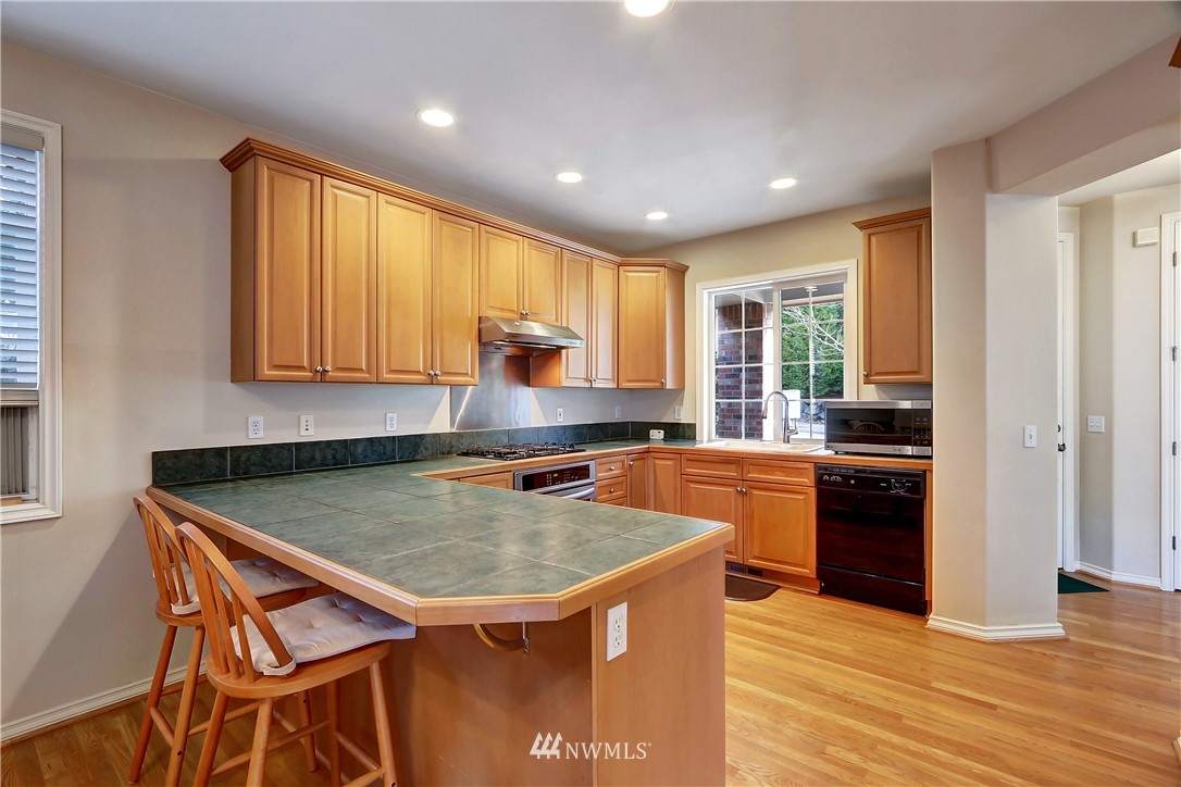 17013 Parkside Way Southeast Renton, WA 98058 - Photo 5 of 26 a kitchen with a stove a sink and a refrigerator